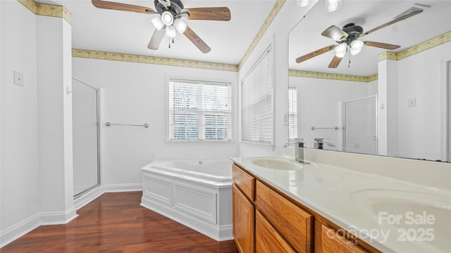 bathroom featuring shower with separate bathtub, hardwood / wood-style floors, vanity, and ceiling fan