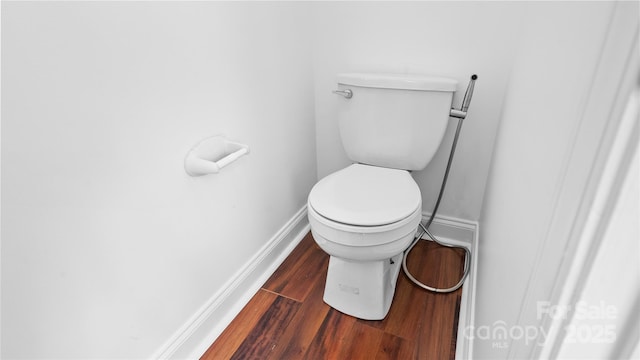 bathroom featuring wood-type flooring and toilet