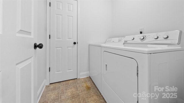 clothes washing area with washer and dryer