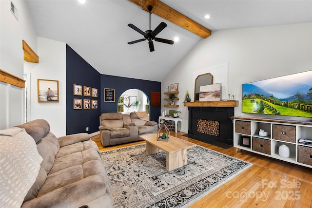 living room featuring beamed ceiling, high vaulted ceiling, hardwood / wood-style floors, and ceiling fan