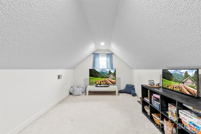 interior space with lofted ceiling, carpet floors, and a textured ceiling