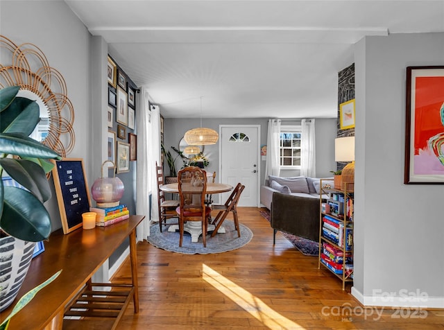 dining space with wood-type flooring