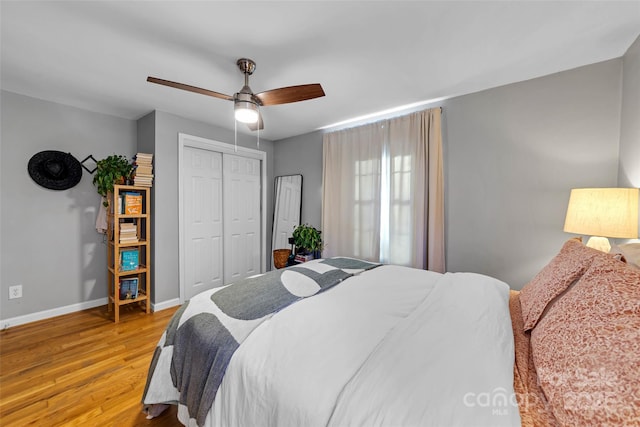 bedroom with a closet, ceiling fan, and light wood-type flooring