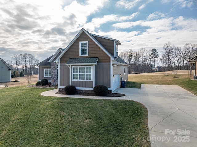 view of front of home with a garage and a front lawn