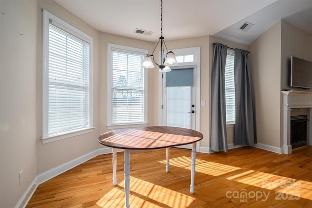 dining space with an inviting chandelier and light wood-type flooring