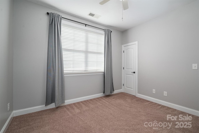 carpeted empty room with plenty of natural light and ceiling fan