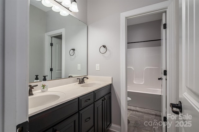 full bathroom with vanity, bathing tub / shower combination, and toilet