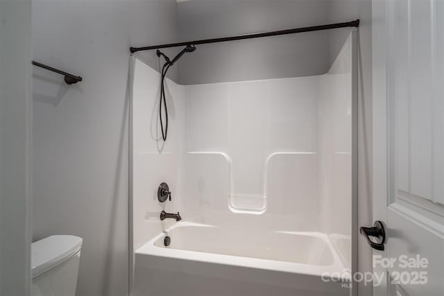 bathroom with shower / bathtub combination and toilet