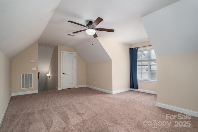 additional living space featuring lofted ceiling, light colored carpet, and ceiling fan