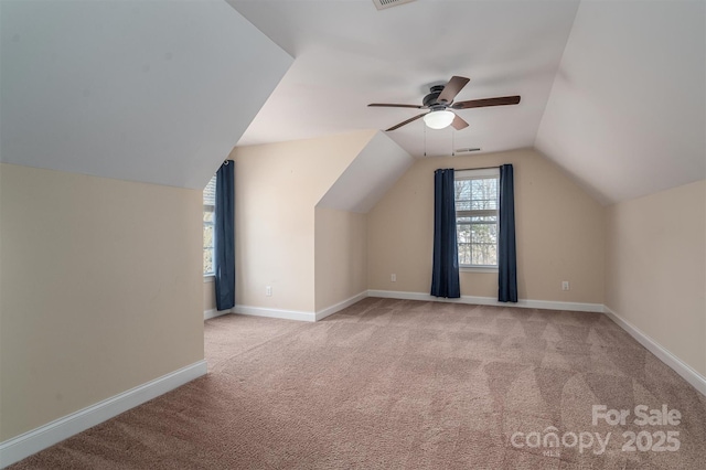 bonus room with lofted ceiling, light colored carpet, and ceiling fan