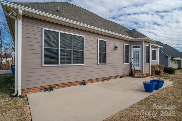 back of property with a patio area and a lawn