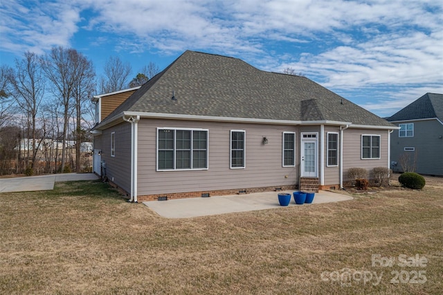 rear view of house with a yard and a patio area