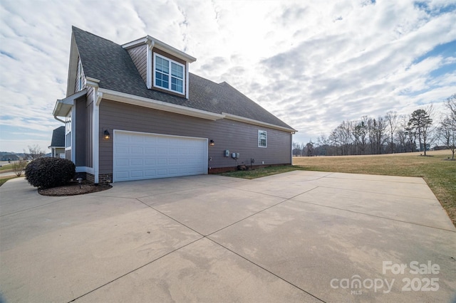 view of side of property with a garage and a lawn