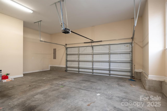 garage with a garage door opener and electric panel