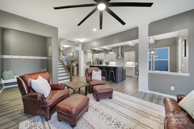 living room featuring hardwood / wood-style floors and ceiling fan