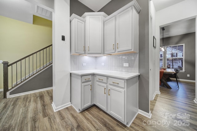 kitchen featuring white cabinetry, dark hardwood / wood-style floors, and decorative backsplash