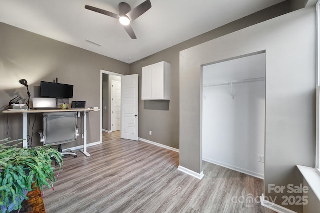 unfurnished office featuring ceiling fan and light hardwood / wood-style floors