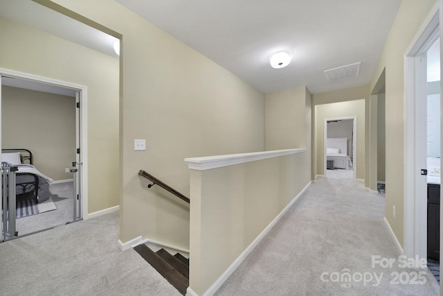 hallway with light colored carpet