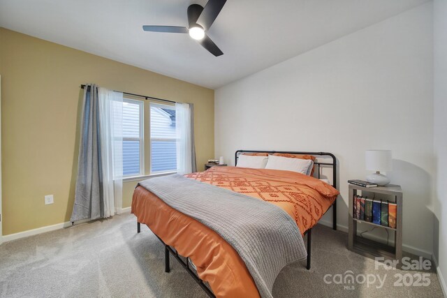 carpeted bedroom with vaulted ceiling and ceiling fan