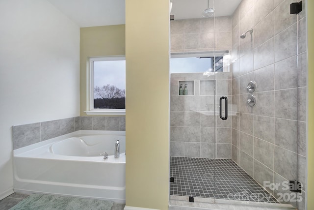 bathroom featuring separate shower and tub