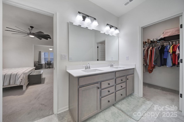 bathroom featuring ceiling fan and vanity