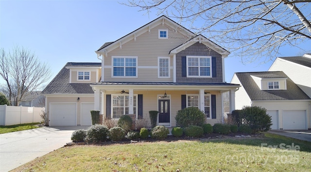 view of front of house featuring a porch, a garage, and a front lawn