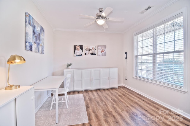 office featuring ornamental molding, light hardwood / wood-style floors, and ceiling fan