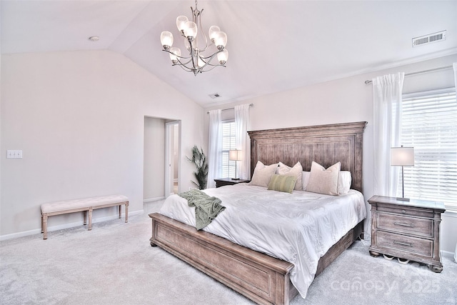 bedroom with light carpet, vaulted ceiling, and a chandelier