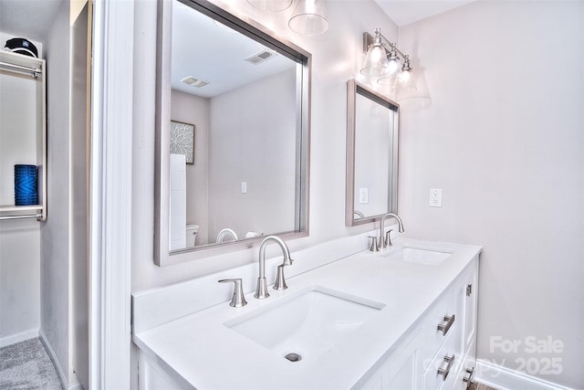 bathroom featuring vanity and toilet