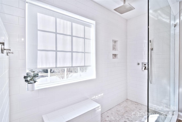 bathroom with tiled shower