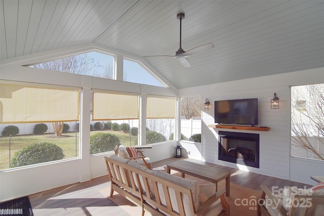 sunroom with ceiling fan and vaulted ceiling