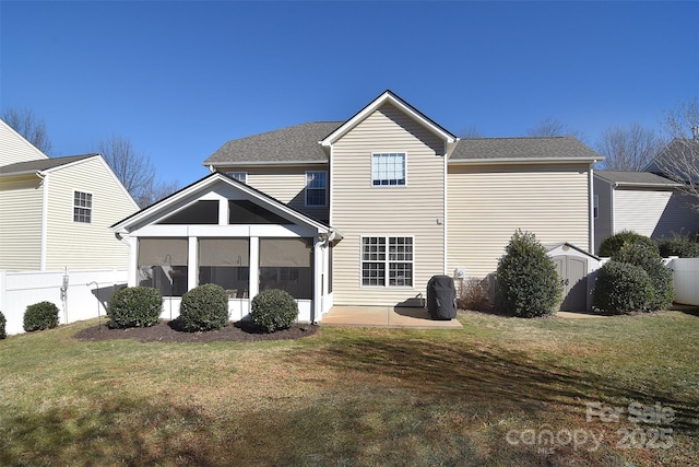 back of property featuring a storage shed, a yard, a patio area, and a sunroom