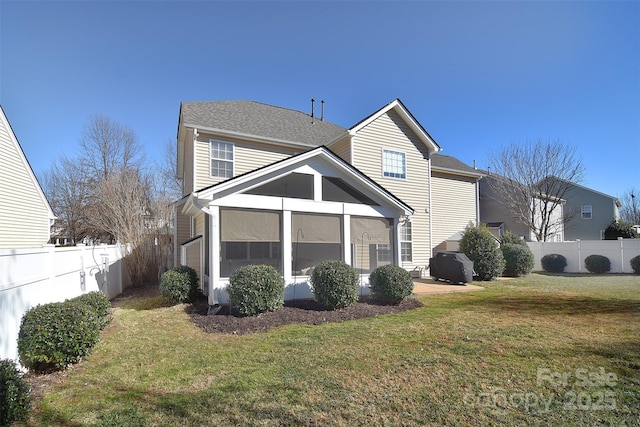 back of property featuring a yard, a patio, and a sunroom