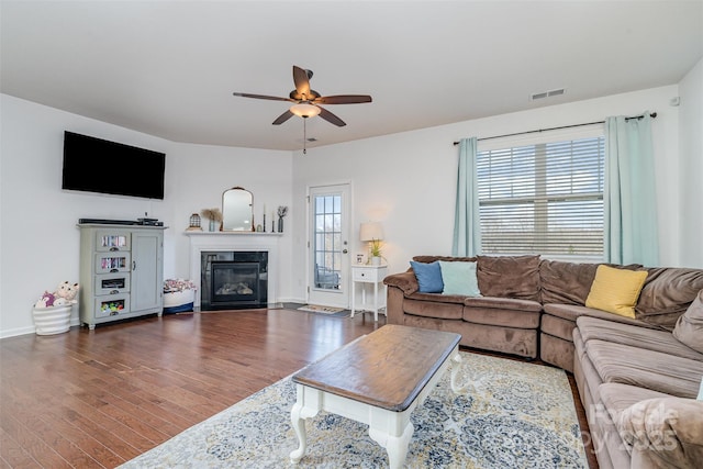 living room featuring dark hardwood / wood-style floors and ceiling fan