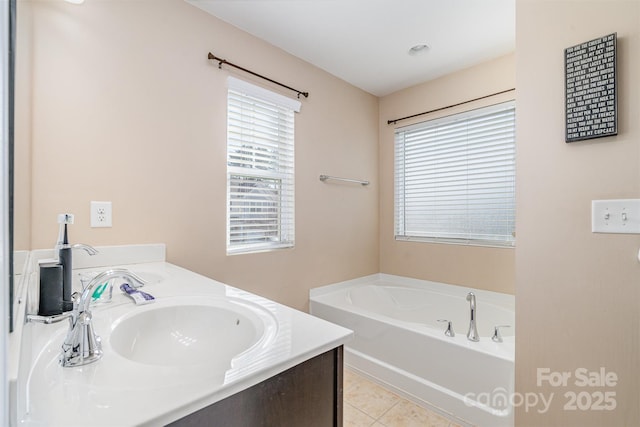 bathroom with vanity, tile patterned floors, and a bathtub