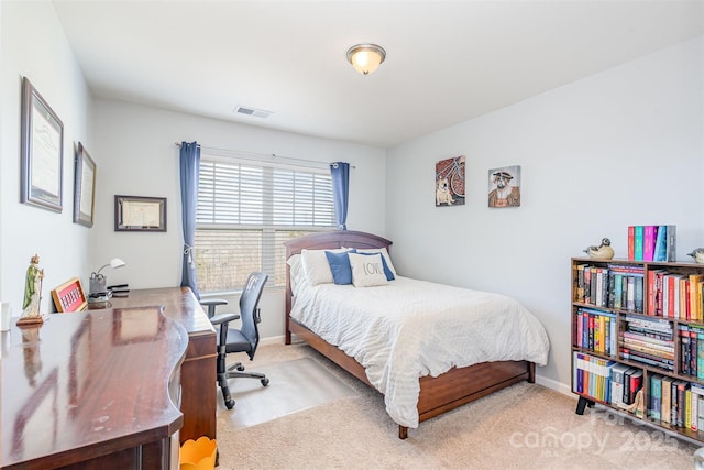 bedroom featuring light carpet