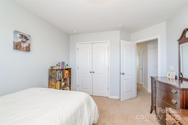 bedroom with light colored carpet and a closet