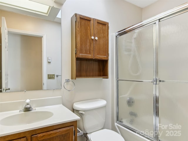 bathroom featuring shower / bath combination with glass door, vanity, and toilet