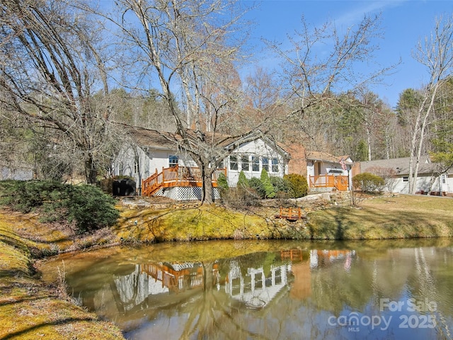 exterior space featuring a deck with water view