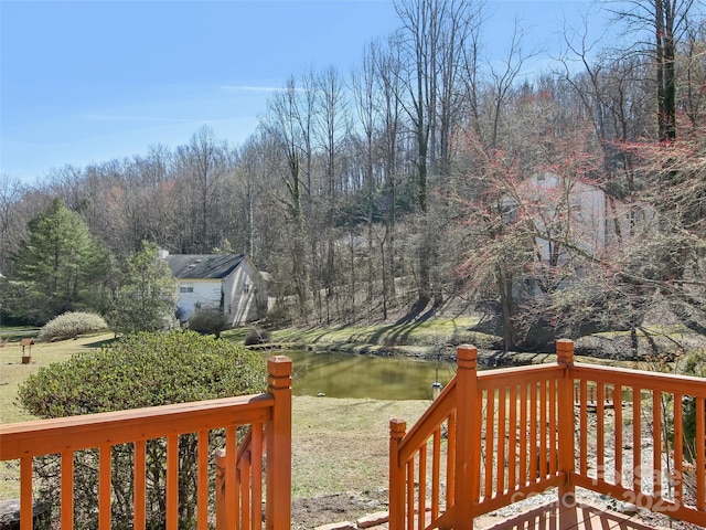 wooden deck featuring a water view and a wooded view