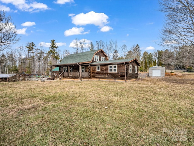 exterior space with a porch, a yard, and a shed