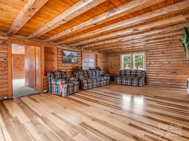 unfurnished living room with wooden ceiling, rustic walls, beam ceiling, and light hardwood / wood-style flooring