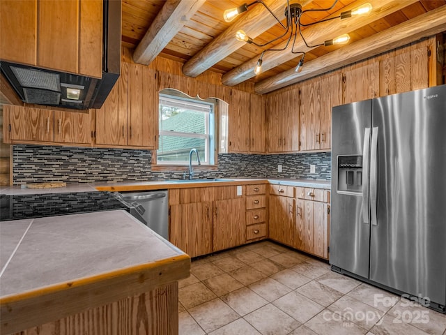 kitchen featuring sink, light tile patterned floors, beam ceiling, stainless steel appliances, and wooden ceiling