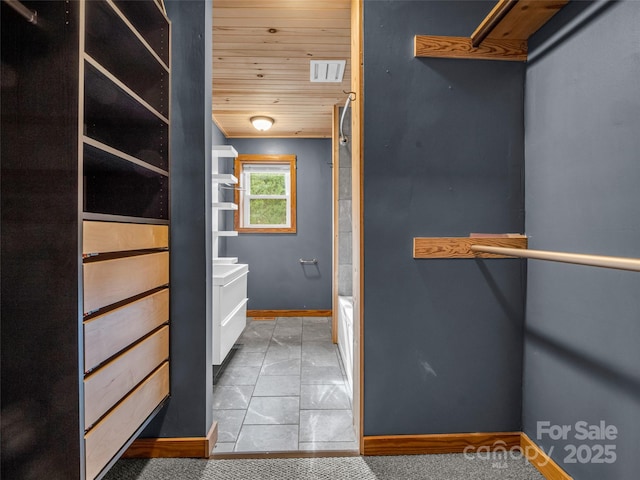 interior space with tile patterned flooring and wood ceiling