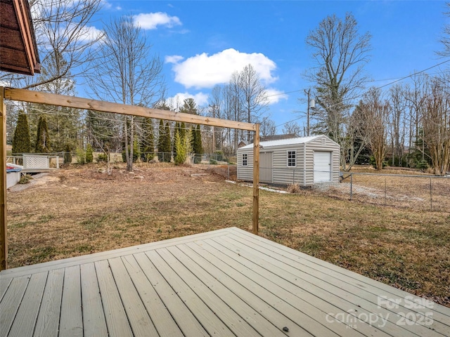 wooden deck featuring an outdoor structure and a lawn