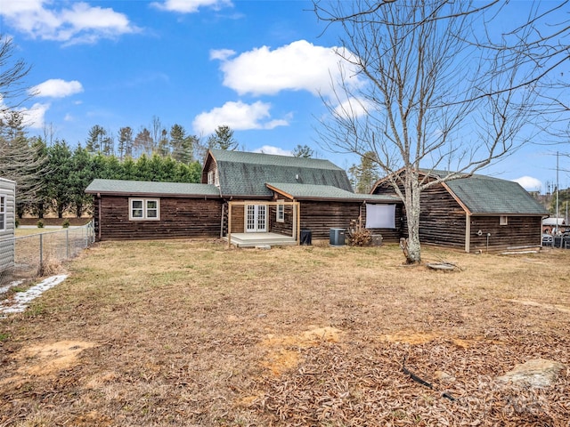 rear view of property featuring a yard