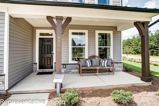 view of exterior entry featuring a porch