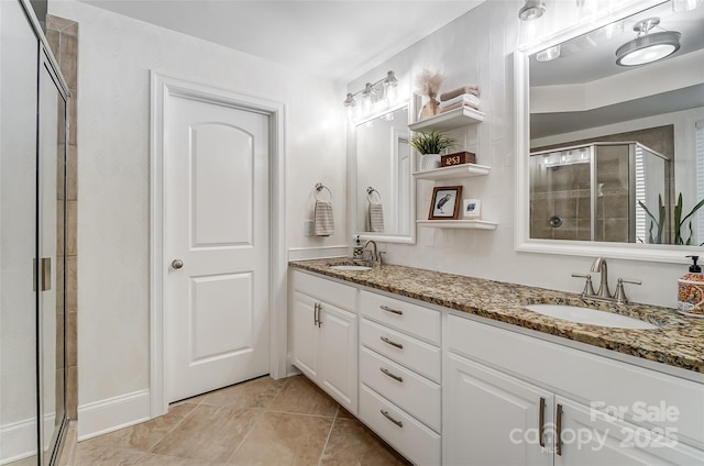 bathroom with vanity, an enclosed shower, and tile patterned floors