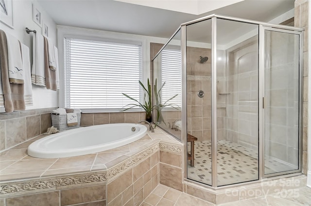 bathroom with independent shower and bath and tile patterned flooring