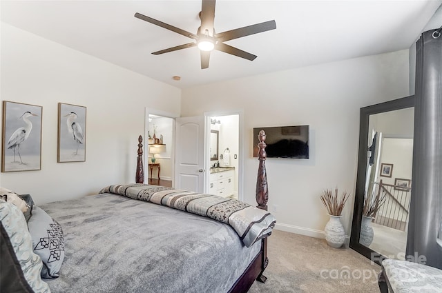 carpeted bedroom with ensuite bathroom and ceiling fan